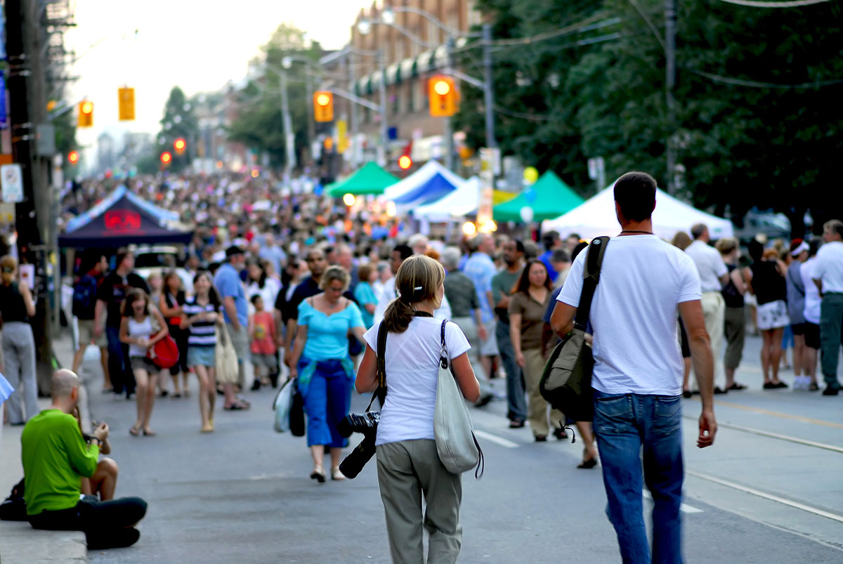 Lakeview & Lincoln Park Summer Festivals Street Festival large crowd walking in street with vendor tents.
