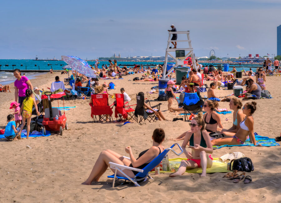 North Avenue Beach in Chicago people hanging at the beach on a sunny day.