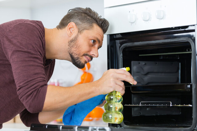 Man cleaning Oven
