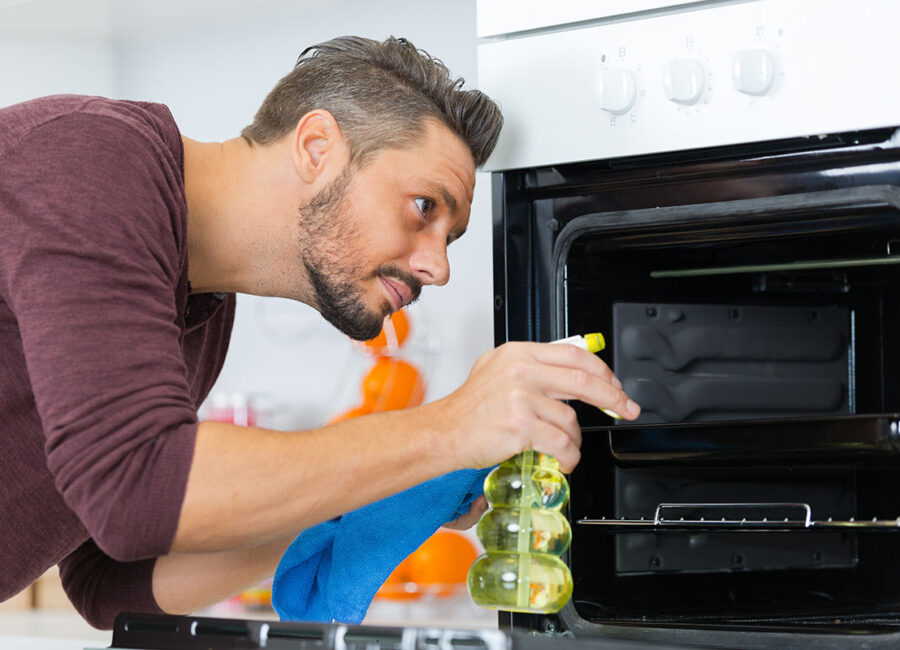 Man cleaning Oven