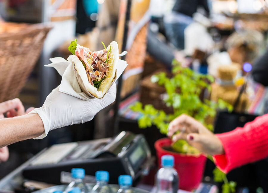 Street Festival Worker Handing Taco to Attendee