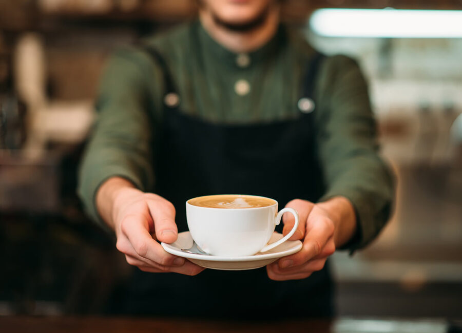 Barista Holding Coffee Cup